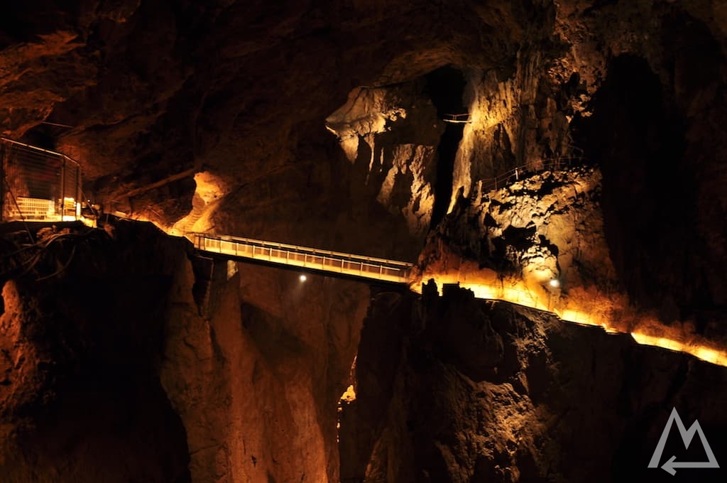 bridge connecting the two walls in the cave, below is the river with strong current in Slovenia